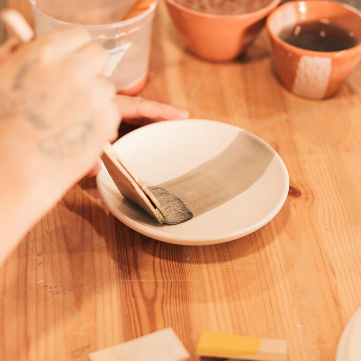 close up woman s hand decorating dish pottery workshop 23 2148155135